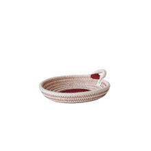 A small woven rope basket with a single loop handle, featuring a cream and burgundy chevron pattern on the exterior and a solid burgundy interior.
